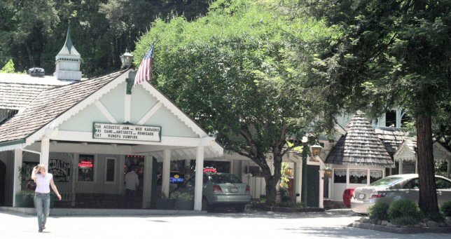 Lodge building among redwoods beside a highway