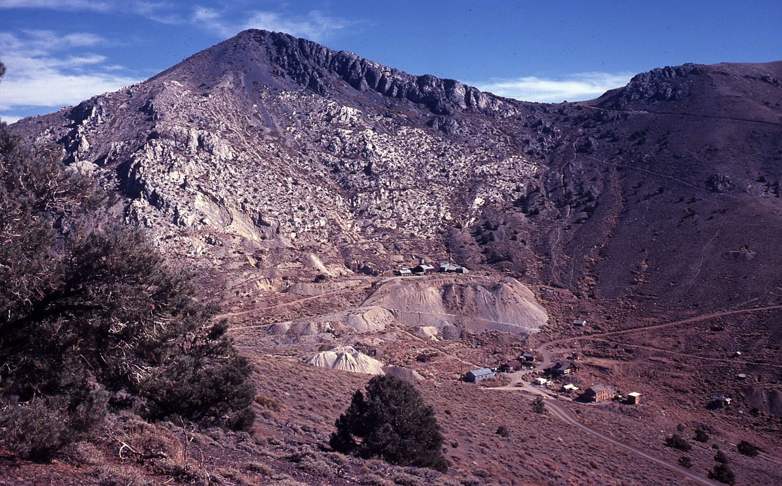 Old wooden mining buildings on a bare mountainside