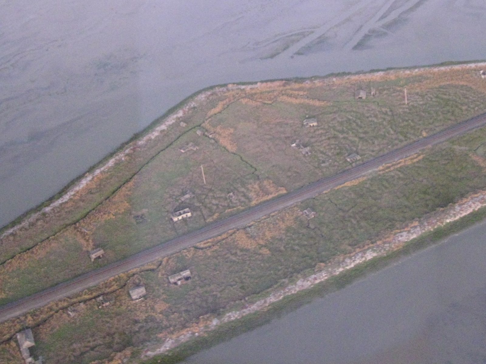 Aerial view of scattered wooden buildings in tidal marsh