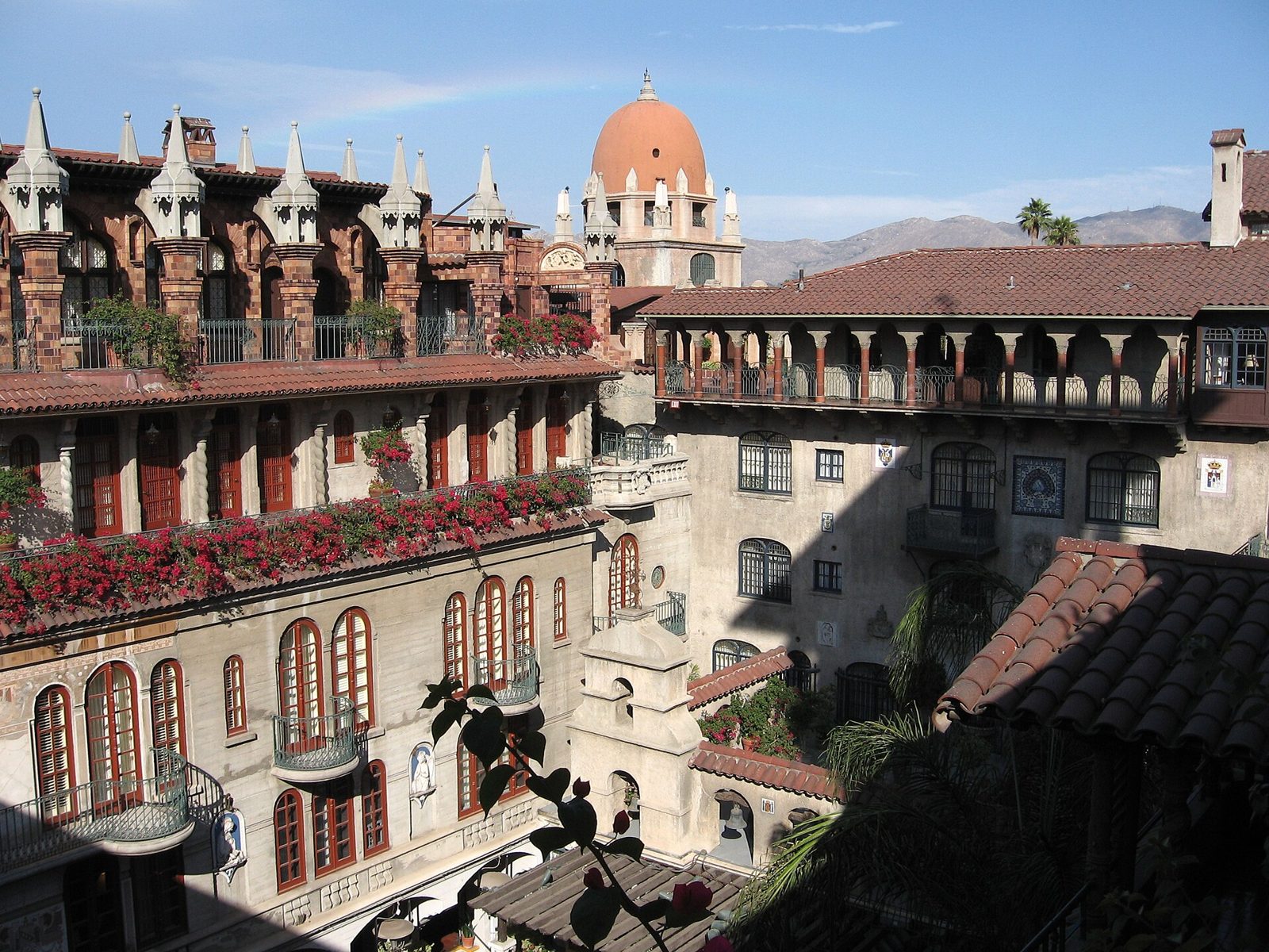 Mission Revival hotel wing with arches and a bell tower