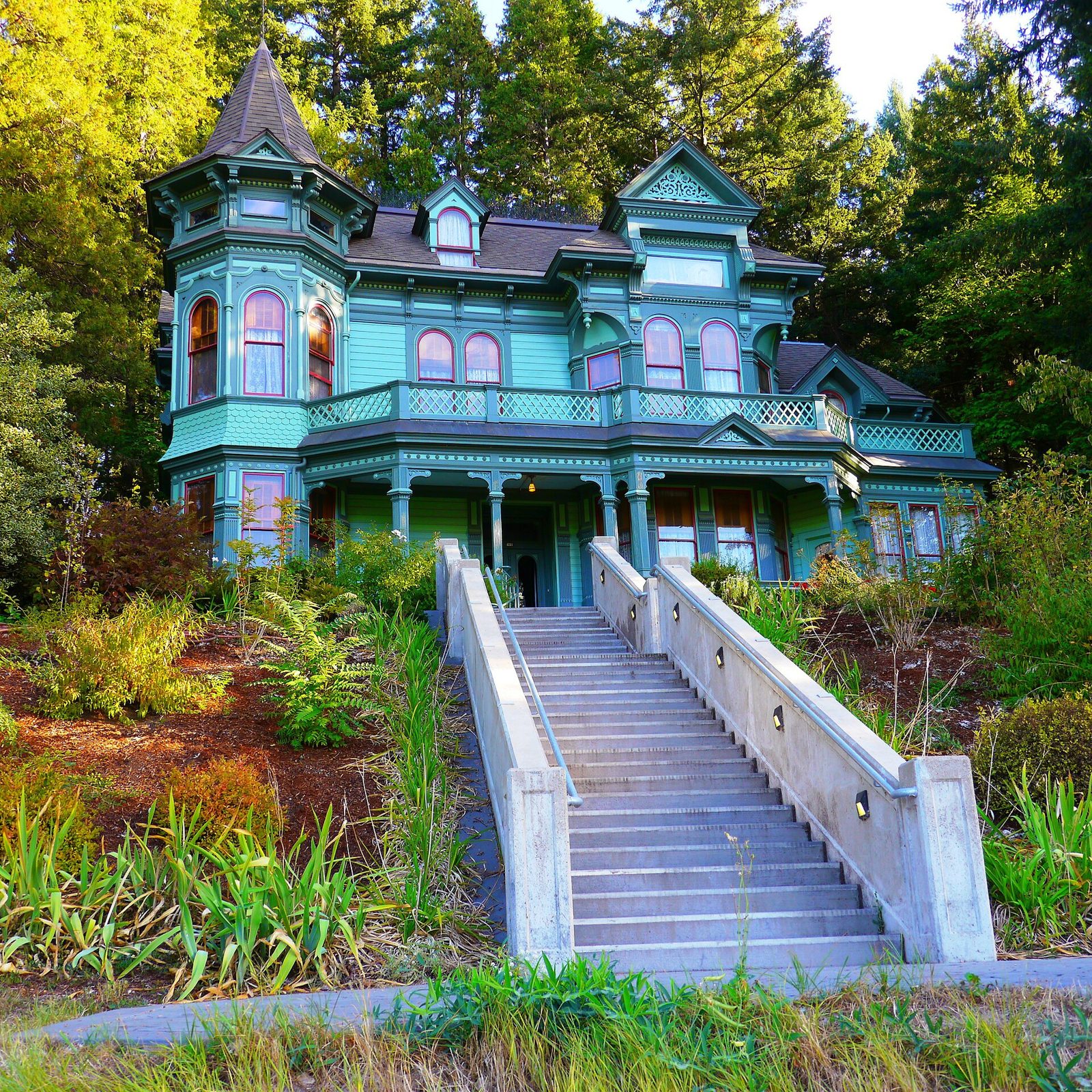 Green Victorian house with a round tower on Skinner Butte