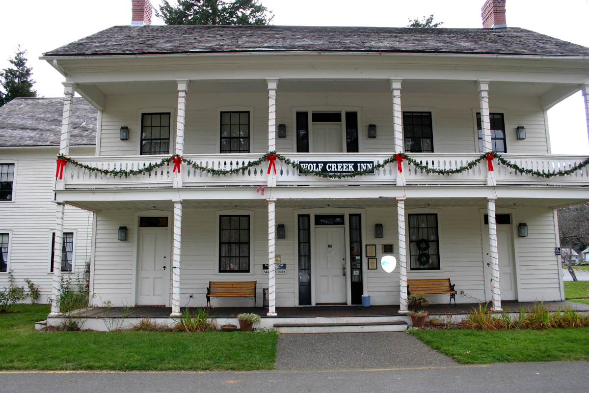 Two-story Wolf Creek Inn with a long front porch